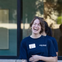 GVSU Alumna laughs with hand over stomach